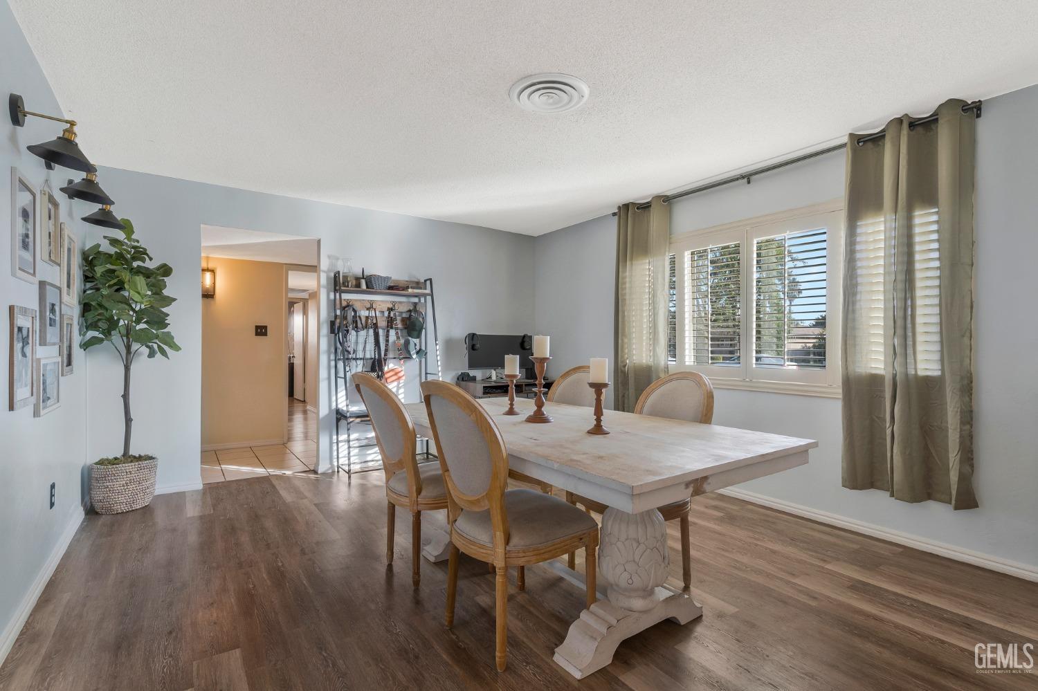 Undisclosed Address Bakersfield, CA 93306 - Photo 7 of 38 a view of a a dining room with furniture window and wooden floor