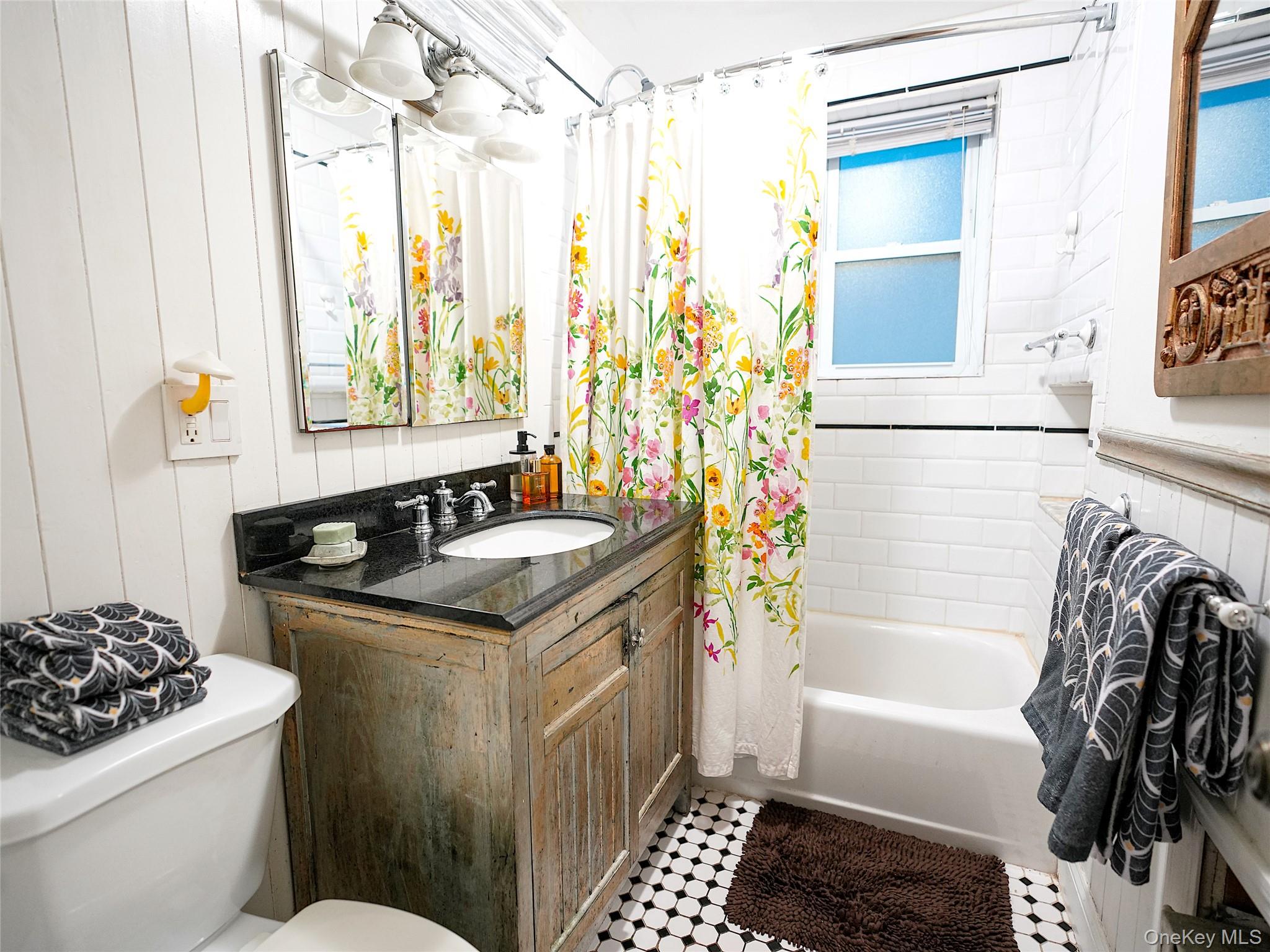 37 Centre Street Bronx, NY 10464 - Photo 25 of 32 a bathroom with a granite countertop sink a toilet and bathtub