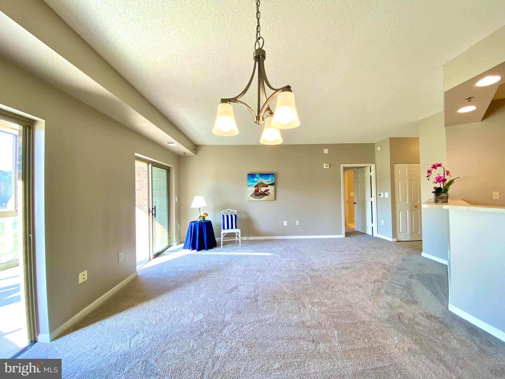 3005 South Leisure World Boulevard, Unit 209 Silver Spring, MD 20906 - Photo 6 of 28 Living area has access to enclosed balcony