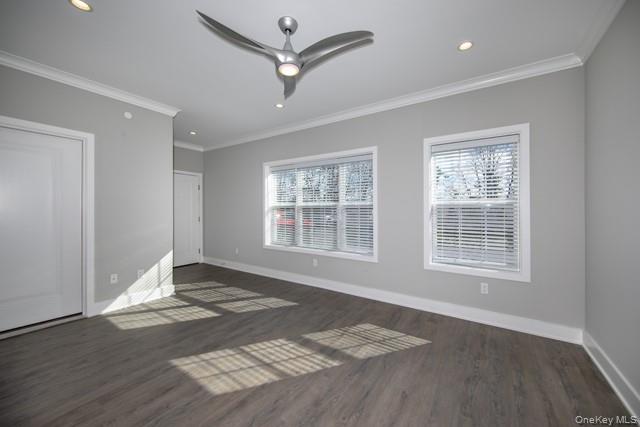 262 Indian Head Road, Unit 211 Kings Park, NY 11754 - Photo 4 of 8 a view of an empty room with wooden floor and a window