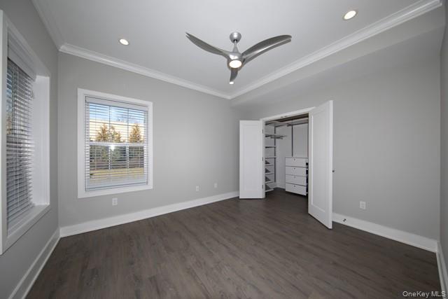 262 Indian Head Road, Unit 211 Kings Park, NY 11754 - Photo 5 of 8 a view of an empty room with wooden floor and a window