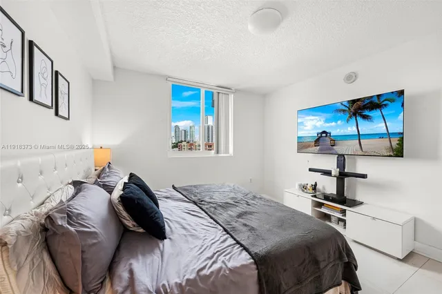 a bedroom with a bed and a painting on the wall