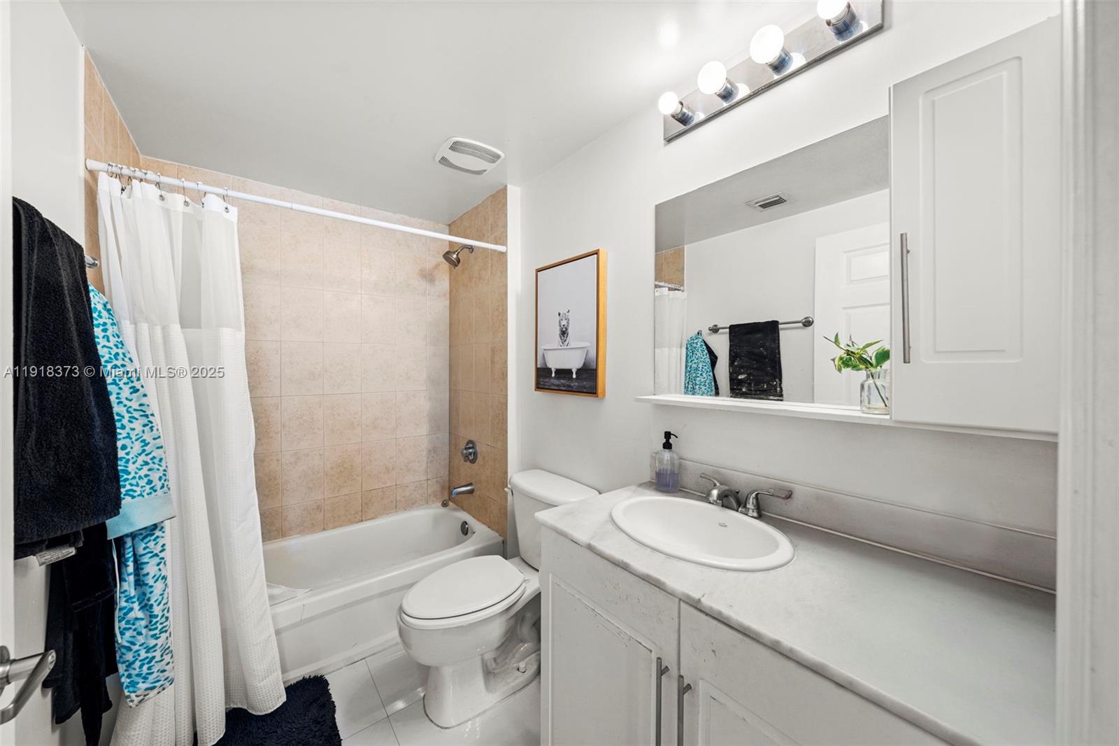275 Northeast 18th Street, Unit 708 Miami, FL 33132 - Photo 21 of 34 a bathroom with a sink a toilet a mirror a vanity and shower