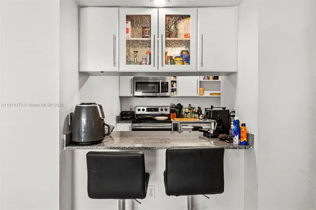 a kitchen with stainless steel appliances granite countertop a stove and a refrigerator