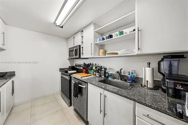 a kitchen with stainless steel appliances granite countertop a sink and cabinets