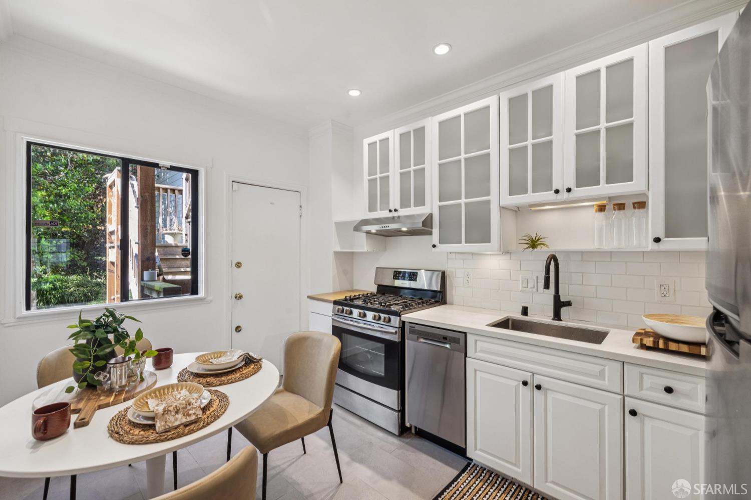 2990 Jackson Street, Unit 4 San Francisco, CA 94115 - Photo 5 of 12 a kitchen with a stove a sink and cabinets