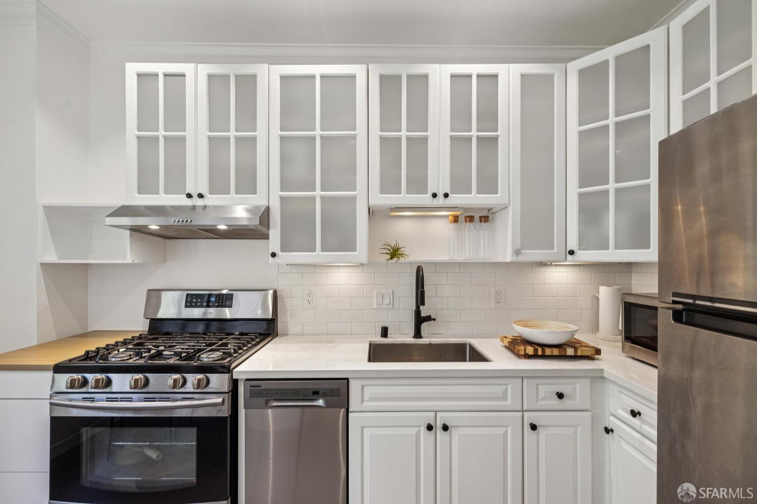 2990 Jackson Street, Unit 4 San Francisco, CA 94115 - Photo 6 of 12 a kitchen with granite countertop a stove and a refrigerator