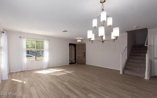 a view of entryway and hall with wooden floor