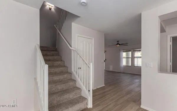 a view of entryway and hall with wooden floor