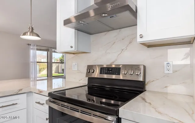 a kitchen with stainless steel appliances granite countertop a stove and a sink
