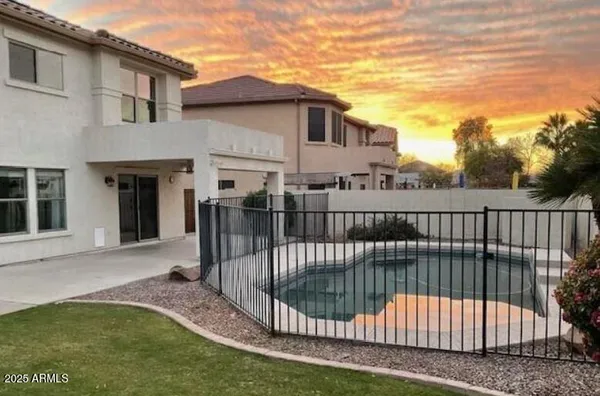 a view of a house with backyard and porch