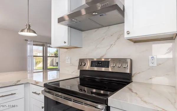 a kitchen with stainless steel appliances granite countertop a stove and a sink