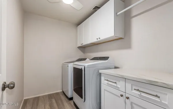 a view of a storage and utility room with washer and dryer