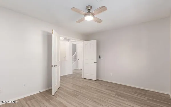 a view of an empty room and wooden floor