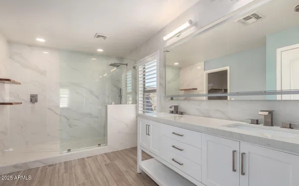 a bathroom with a shower sink and mirror