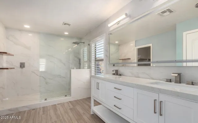 a bathroom with a shower sink and mirror