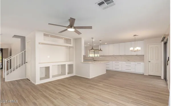 a view of kitchen with wooden floor and electronic appliances