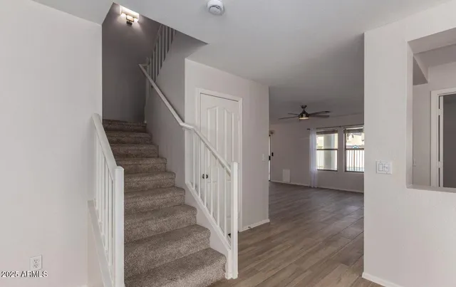 a view of entryway and hall with wooden floor