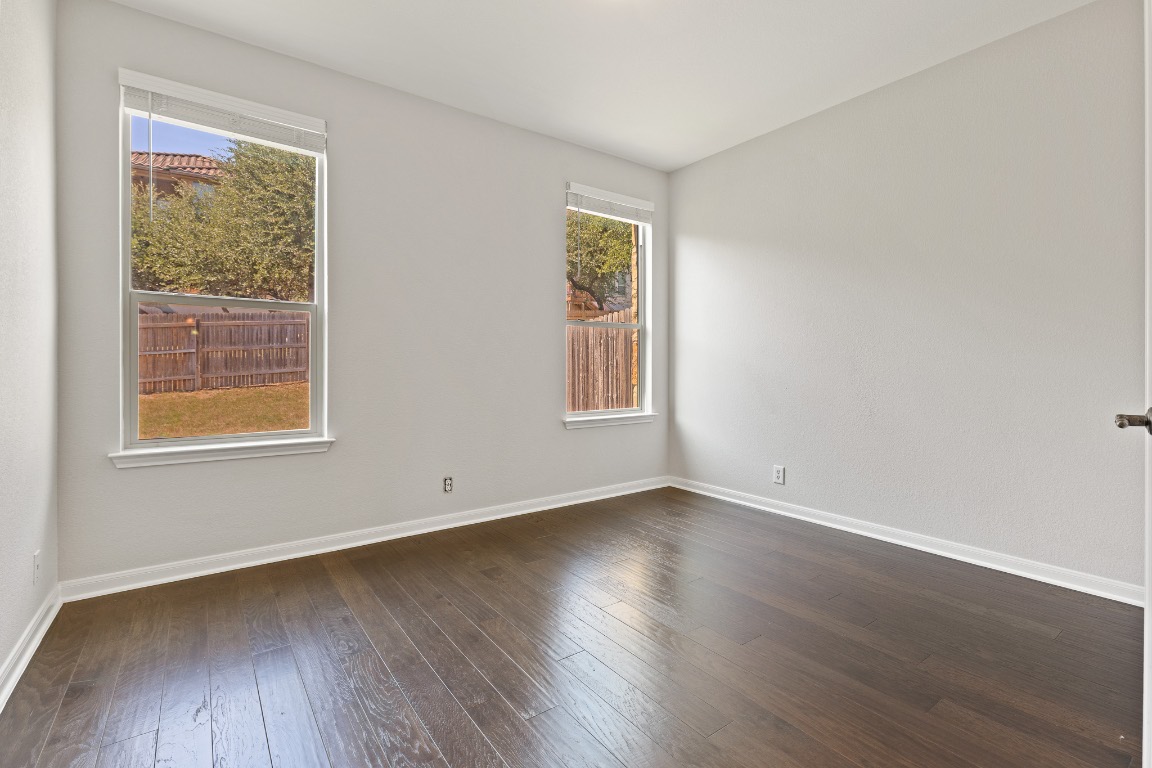 506 Hummingbird Lane, Unit A Austin, TX 78734 - Photo 10 of 36 a view of an empty room with wooden floor and a window