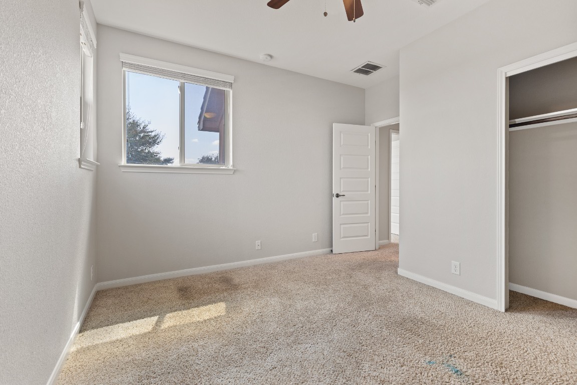 506 Hummingbird Lane, Unit A Austin, TX 78734 - Photo 22 of 36 an empty room with windows and closet