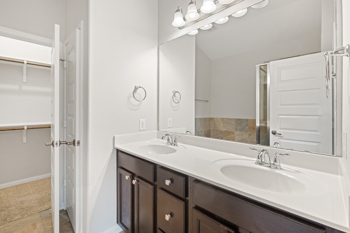 506 Hummingbird Lane, Unit A Austin, TX 78734 - Photo 27 of 36 Bathroom with a spacious closet and double vanity