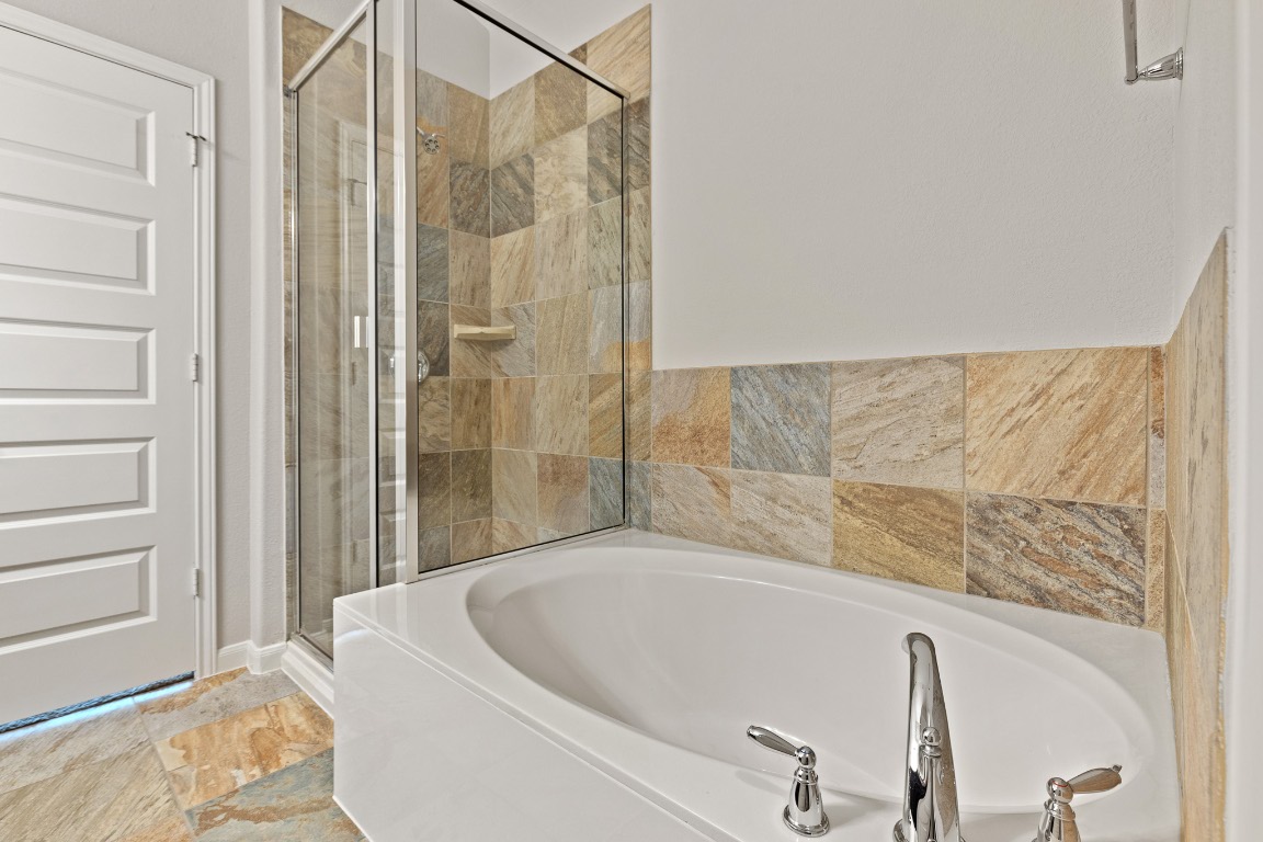 506 Hummingbird Lane, Unit A Austin, TX 78734 - Photo 28 of 36 Bathroom with a shower stall and a bath