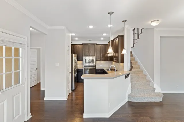 a view of entryway and hall with wooden floor