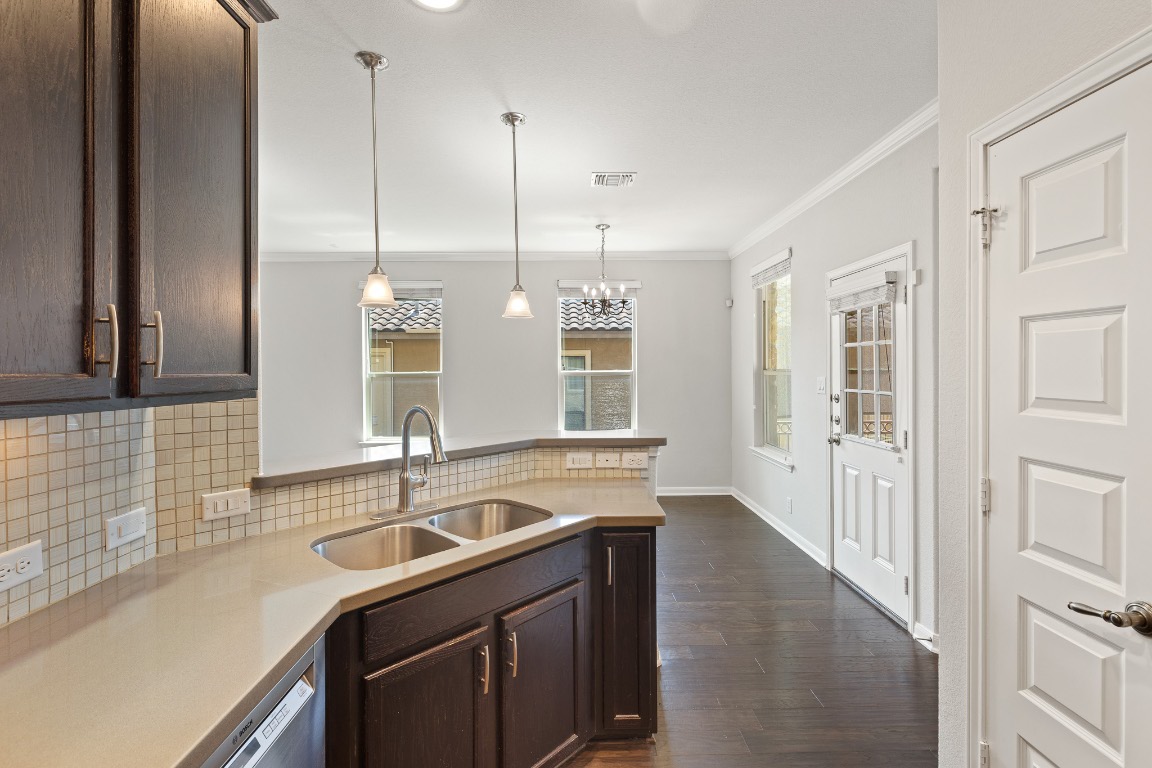 506 Hummingbird Lane, Unit A Austin, TX 78734 - Photo 8 of 36 a kitchen with stainless steel appliances granite countertop a sink a stove and a wooden floor