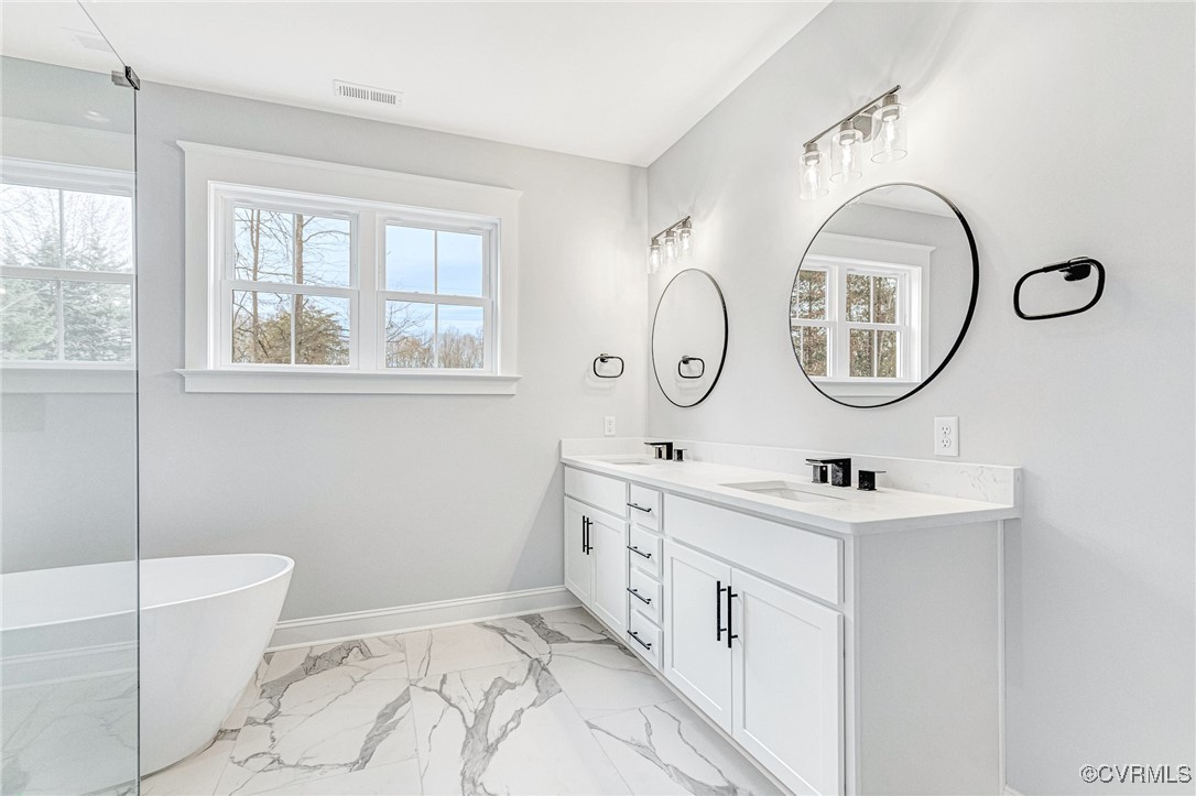 16652 Parsons Road Beaverdam, VA 23015 - Photo 31 of 44 a bathroom with a double vanity sink a toilet and a mirror
