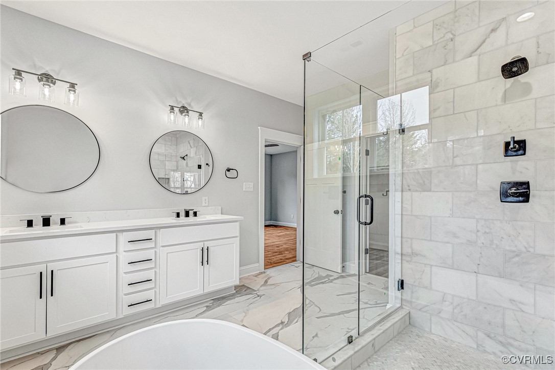 16652 Parsons Road Beaverdam, VA 23015 - Photo 33 of 44 a spacious bathroom with a double vanity sink toilet mirror and shower