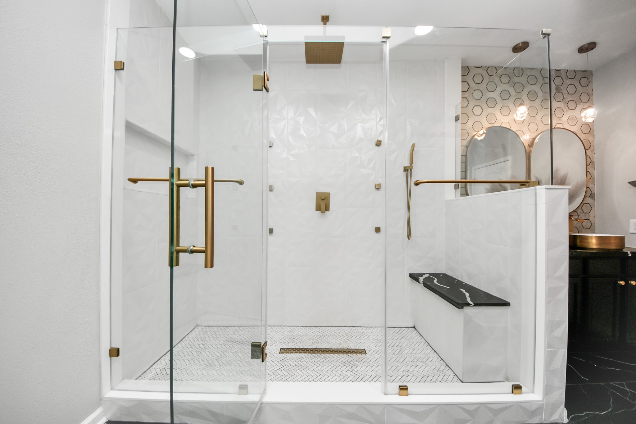 6931 Primrose Road Baytown, TX 77521 - Photo 24 of 50 Spacious walk-in glass shower with rainfall showerhead, bench seating, and gold fixtures.