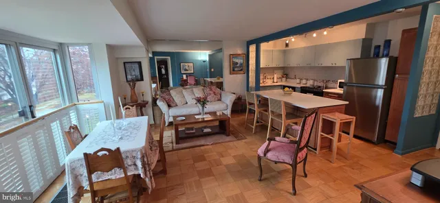 a dining room with furniture and wooden floor
