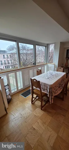 a view of a dining room with furniture and a flat screen tv