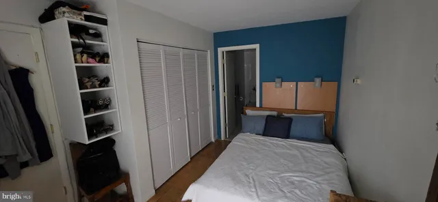 a bedroom with a bed and cabinets