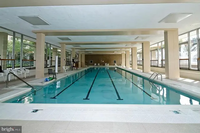 a view of a chair and table in the back yard of the house