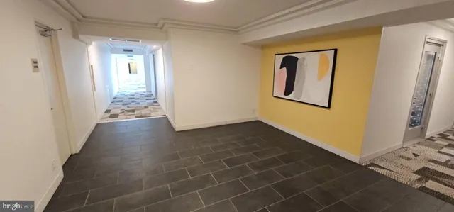 a view of an empty room and wooden floor