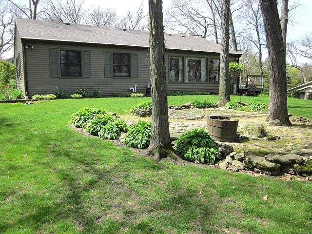 2037 Hillsdown Road Lake Summerset, IL 61019 - Photo 17 of 24 a view of a brick house with a yard and plants