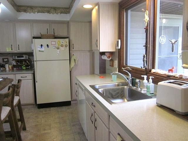 2037 Hillsdown Road Lake Summerset, IL 61019 - Photo 3 of 24 a kitchen with a sink a refrigerator and cabinets