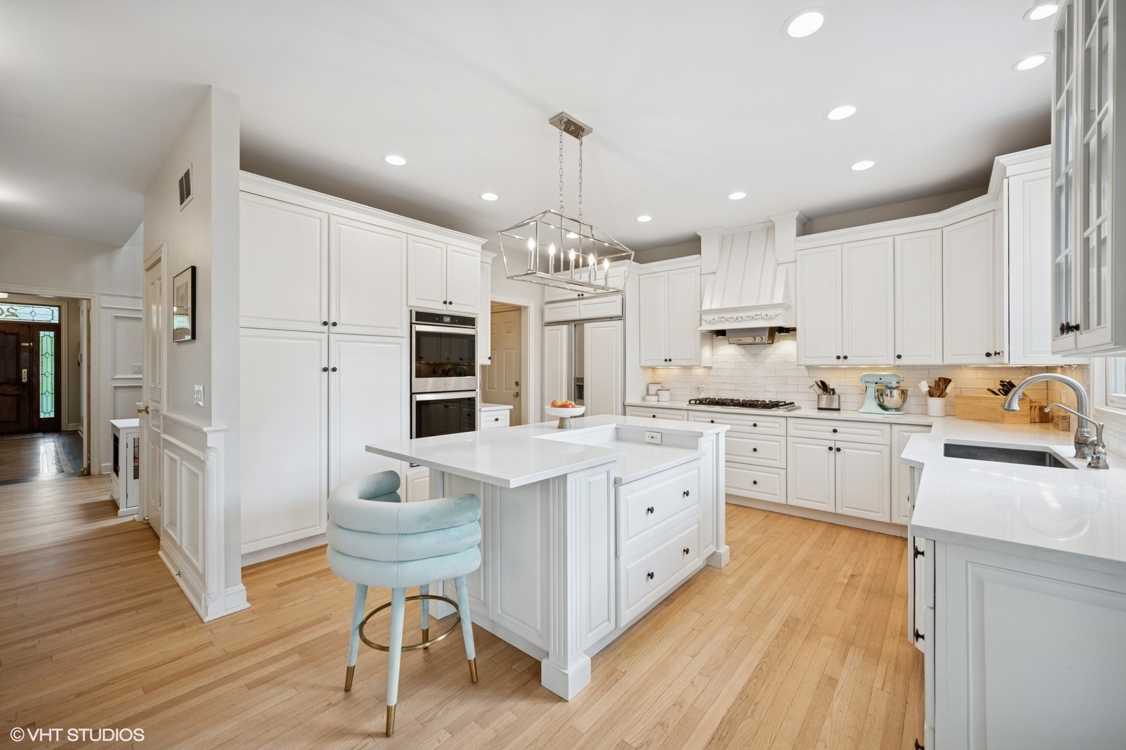 2007 Wilmette Avenue Wilmette, IL 60091 - Photo 11 of 35 a kitchen with stainless steel appliances kitchen island granite countertop a refrigerator a stove a sink dishwasher and white cabinets with wooden floor