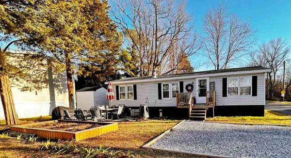 a view of a house with pool and chairs