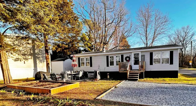 a view of a house with pool and chairs