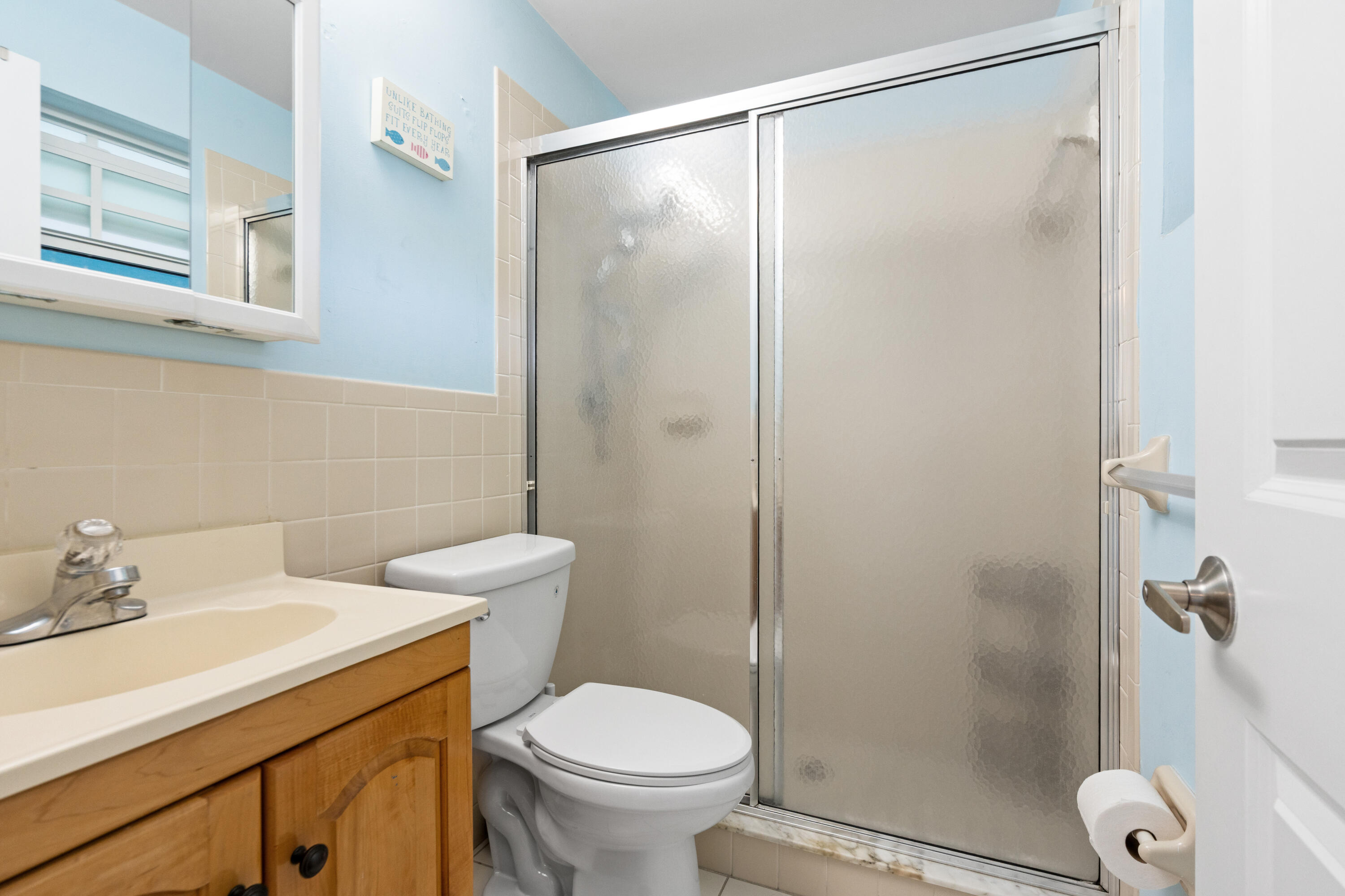249 Center Street, Unit 2C Jupiter, FL 33458 - Photo 20 of 29 a bathroom with a shower a toilet and a sink