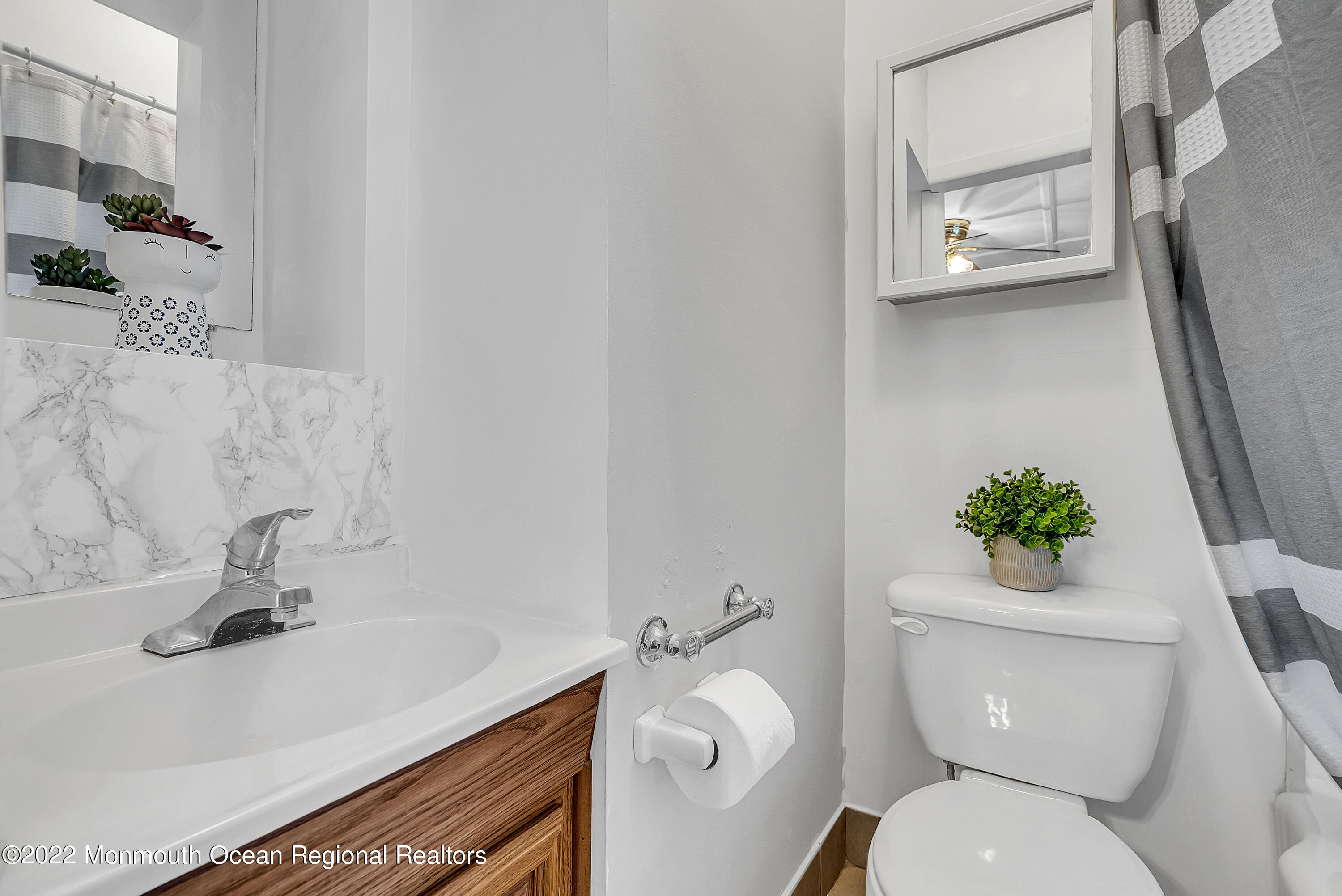 97 Mechanic Street Red Bank, NJ 07701 - Photo 12 of 28 a bathroom with a sink mirror vanity and toilet