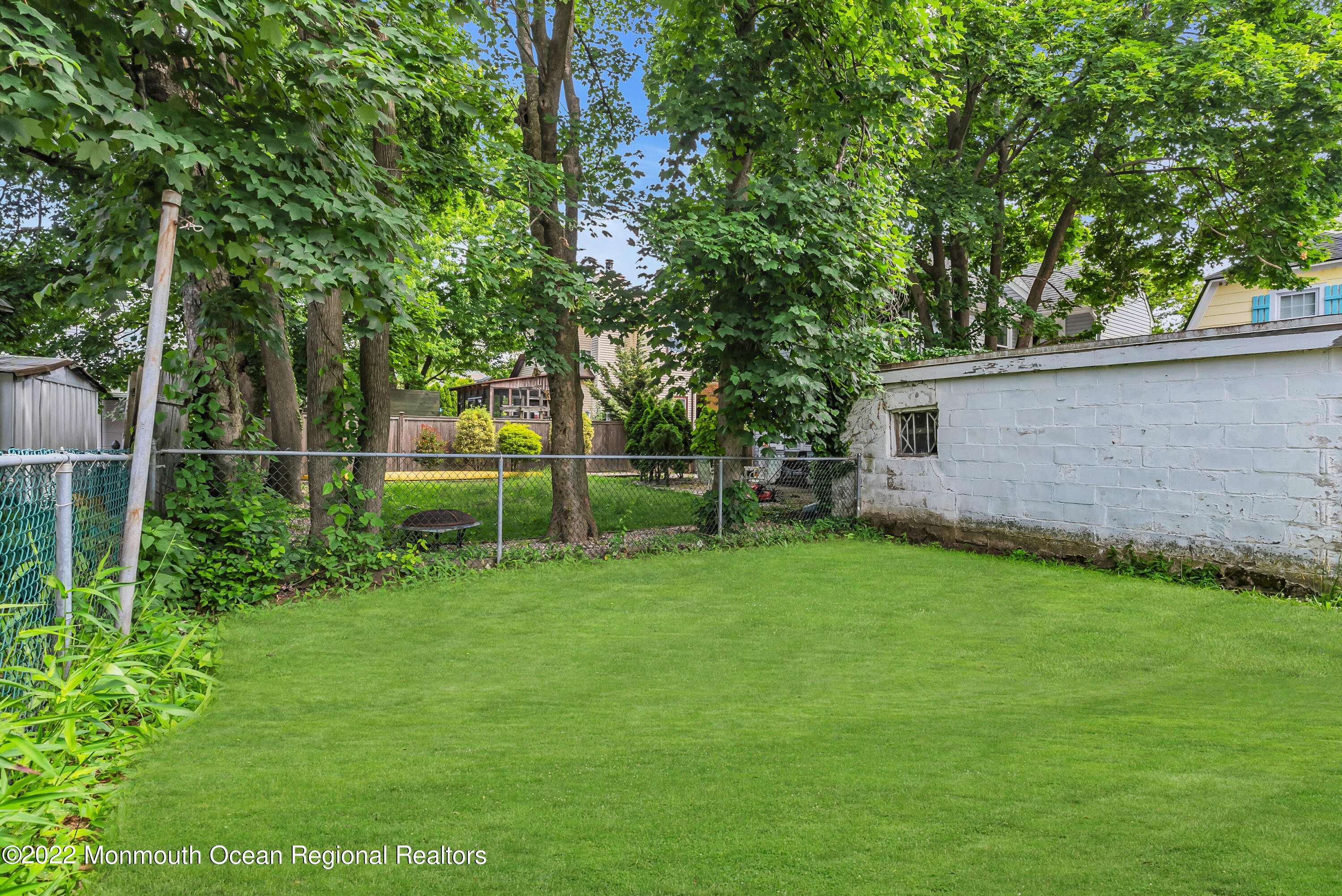 97 Mechanic Street Red Bank, NJ 07701 - Photo 26 of 28 a view of a backyard with large trees