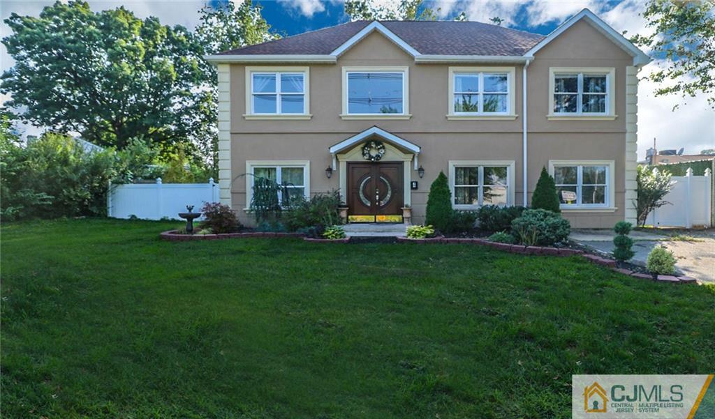 4 Colton Road Edison, NJ 08817 - Photo 1 of 25 a front view of a house with a yard and trees