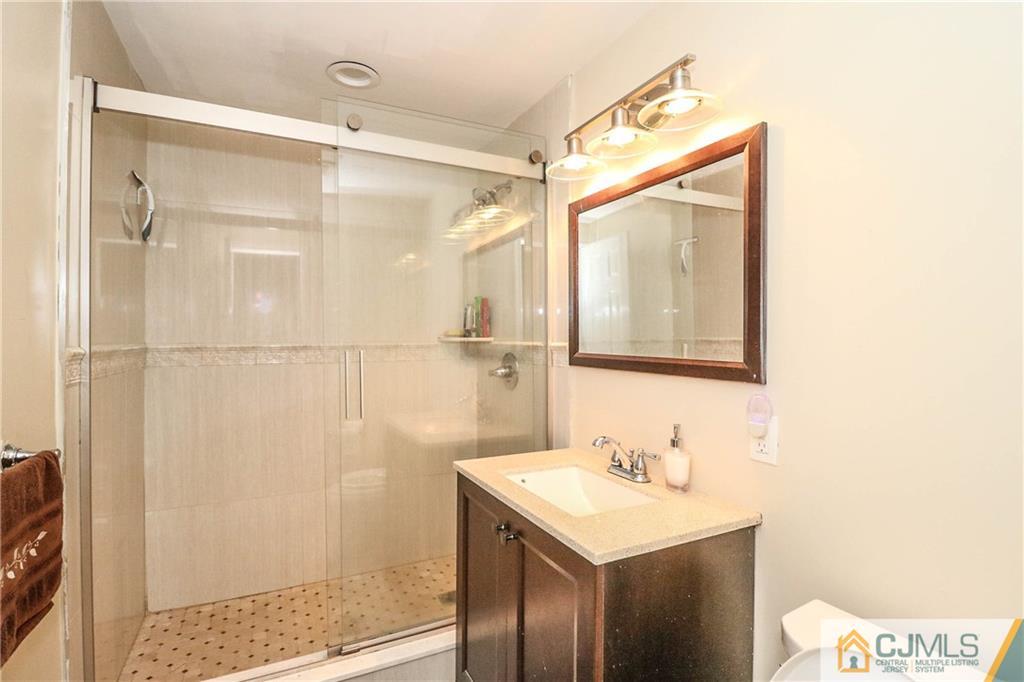 4 Colton Road Edison, NJ 08817 - Photo 14 of 25 a bathroom with a sink and a mirror