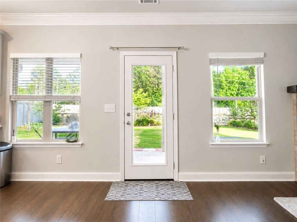 3359 Elkhorn Ridge Run Dacula, GA 30019 - Photo 15 of 35 a view of an empty room with wooden floor and a window