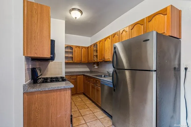 a kitchen with stainless steel appliances granite countertop a refrigerator and a stove