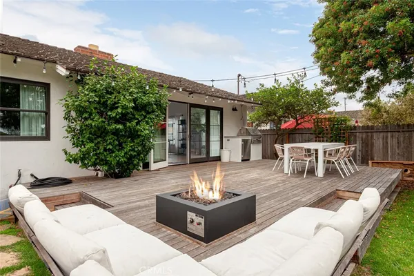 a view of a patio with couches table and chairs and potted plants