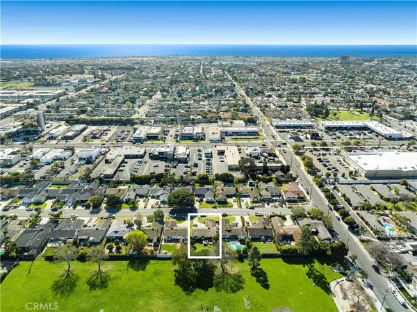 an aerial view of residential houses with yard
